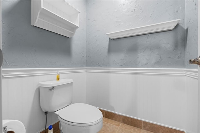 bathroom with tile patterned flooring and toilet