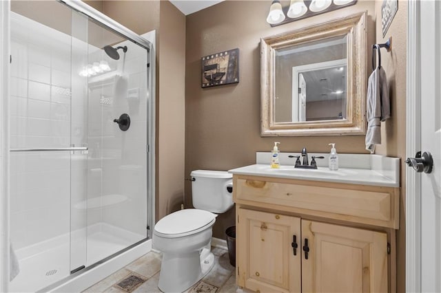 bathroom with vanity, toilet, and an enclosed shower