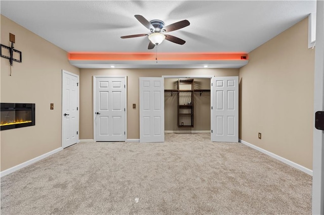 interior space with light colored carpet and ceiling fan