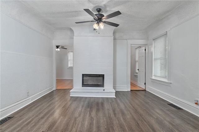3229 Wayne Ave, Kansas City, MO 64109 - unfurnished living room with visible vents, a ceiling fan, and wood finished floors