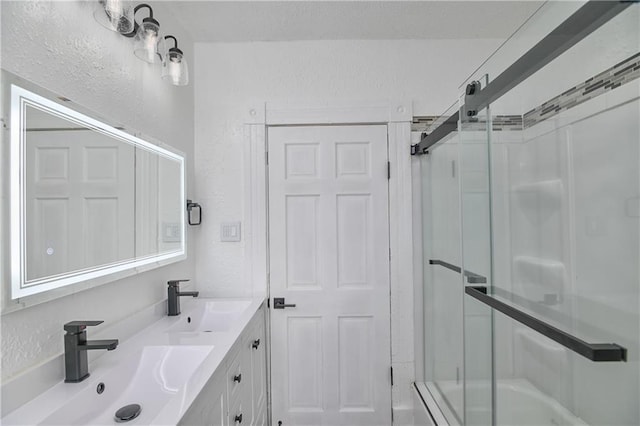 3229 Wayne Ave, Kansas City, MO 64109 - bathroom featuring an enclosed shower, a textured wall, and a sink