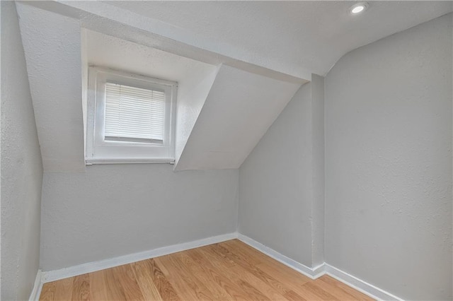 3229 Wayne Ave, Kansas City, MO 64109 - additional living space with baseboards, lofted ceiling, and wood finished floors