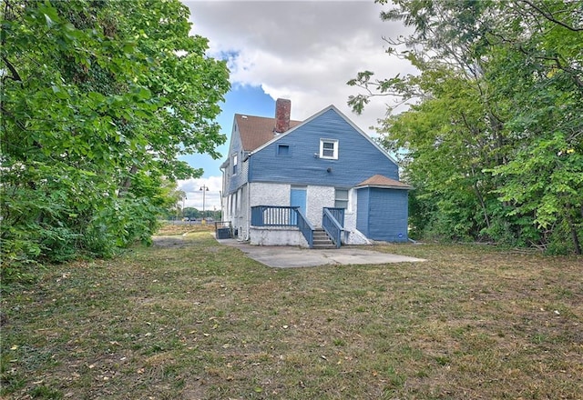 back of house featuring a yard and a patio area