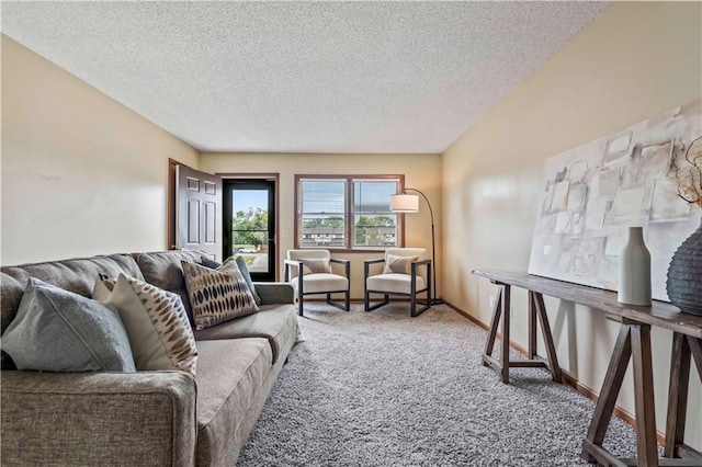 living room with a textured ceiling and carpet floors