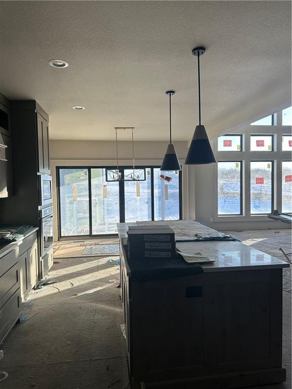 kitchen with a kitchen island, plenty of natural light, and appliances with stainless steel finishes