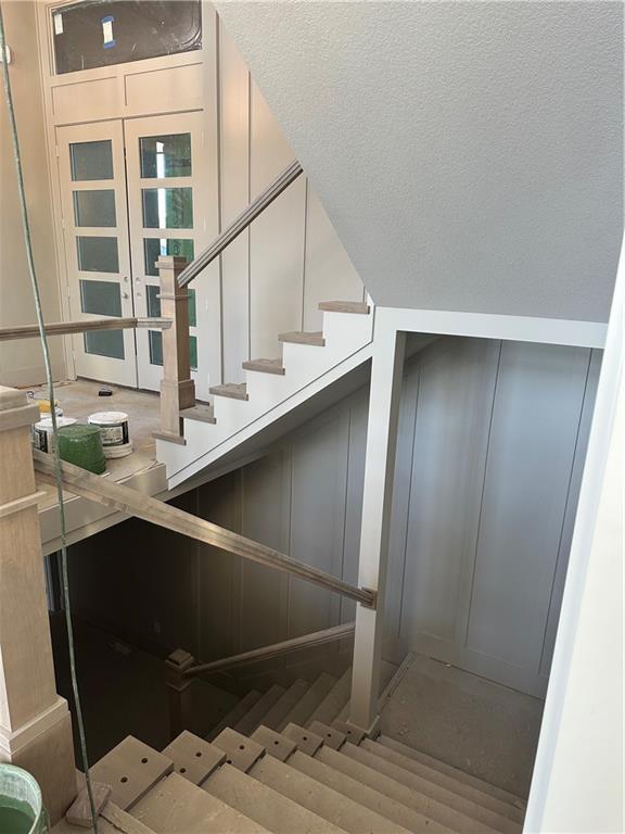 staircase with a textured ceiling