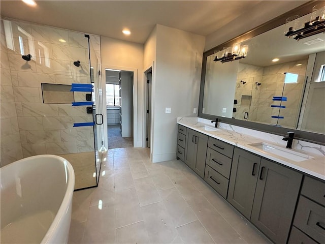 full bath with a soaking tub, double vanity, a stall shower, and a sink