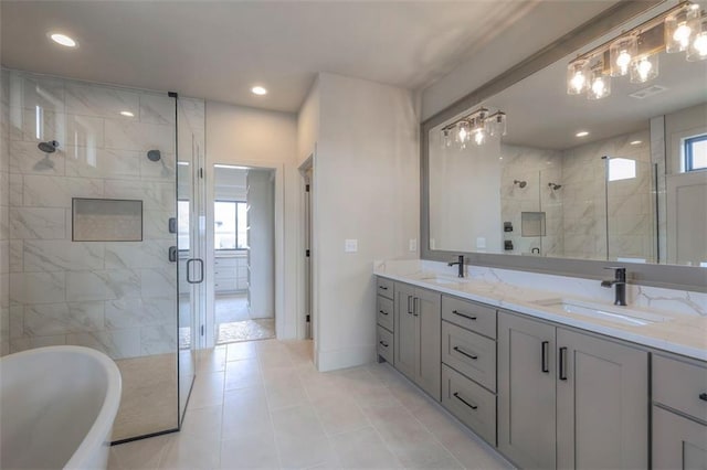 full bath featuring double vanity, a soaking tub, a stall shower, and a sink