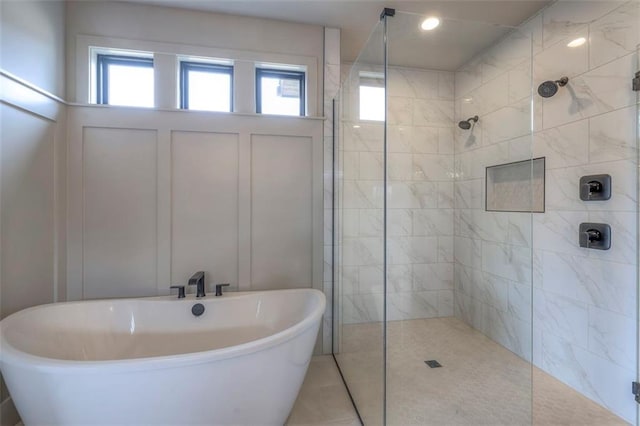 full bathroom with tiled shower and a soaking tub