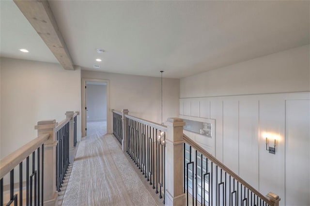 hallway with recessed lighting, an upstairs landing, beam ceiling, and carpet floors