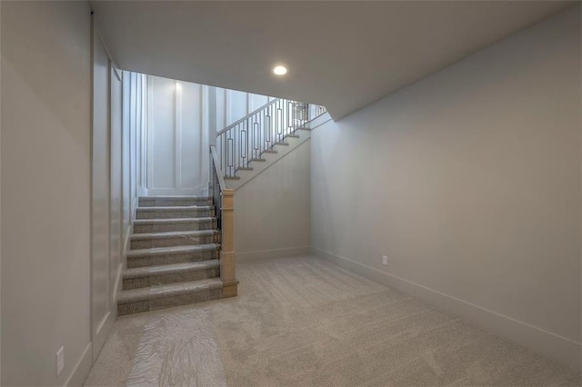 staircase with recessed lighting, baseboards, and carpet floors