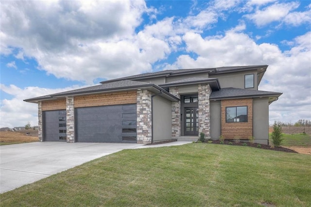 prairie-style house featuring stucco siding, an attached garage, concrete driveway, stone siding, and a front yard