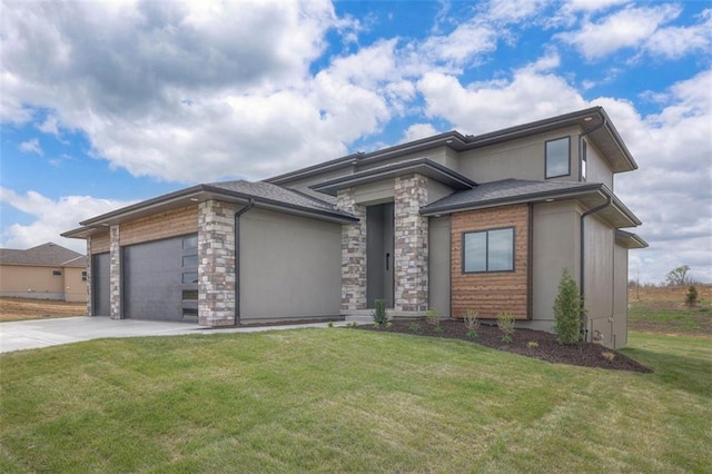 prairie-style house with a garage, driveway, stone siding, and a front lawn