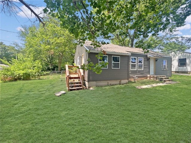 back of house with a lawn