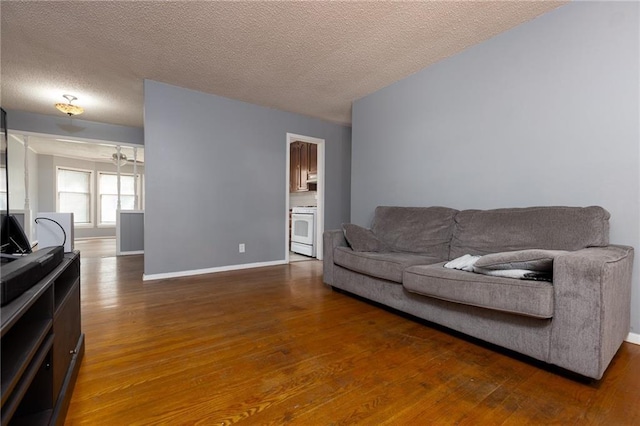 living room with hardwood / wood-style floors and a textured ceiling