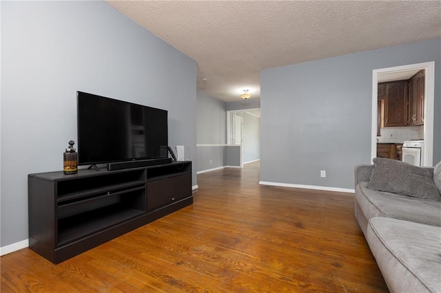 living room with wood-type flooring and a textured ceiling