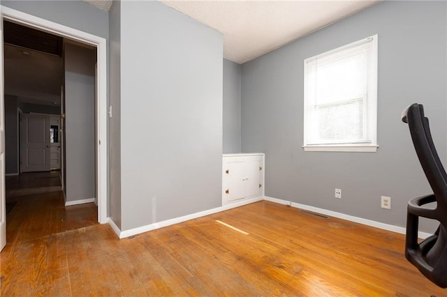 unfurnished office with wood-type flooring