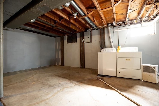 basement featuring separate washer and dryer and electric panel