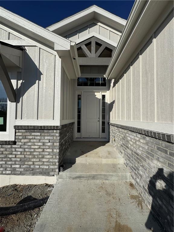 doorway to property with brick siding