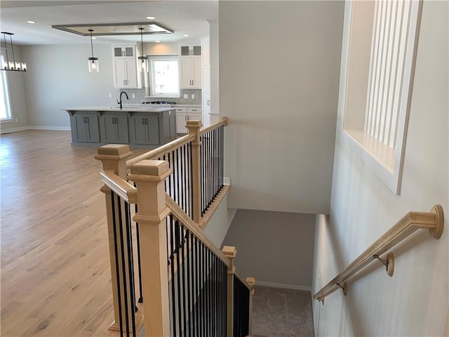 stairs featuring recessed lighting, wood finished floors, and baseboards