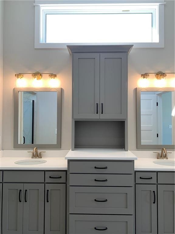 bathroom with a sink and double vanity