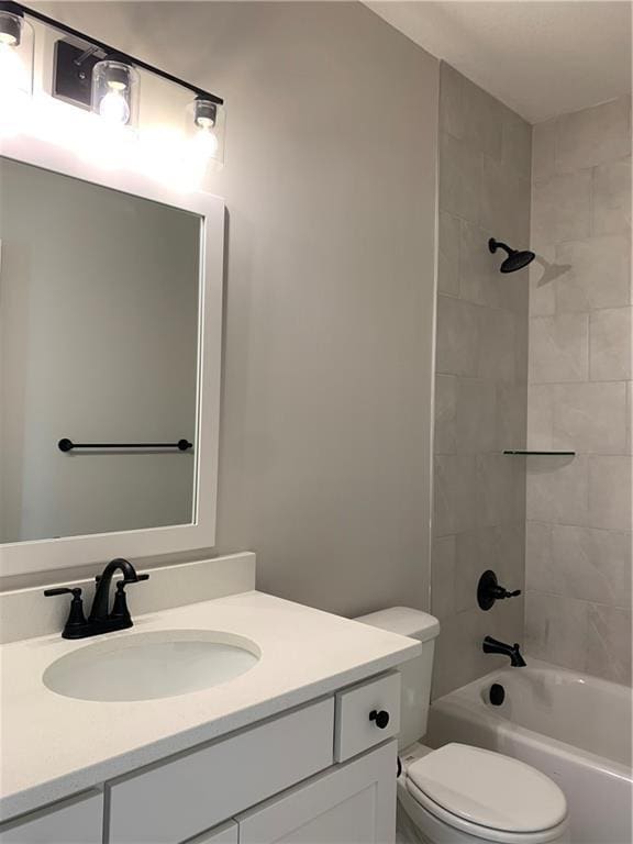 bathroom with toilet, bathtub / shower combination, and vanity