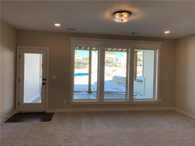 doorway featuring carpet, visible vents, baseboards, and recessed lighting