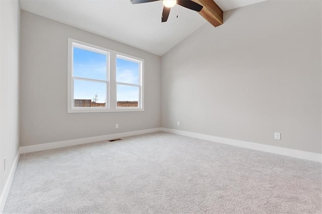 carpeted empty room with ceiling fan and vaulted ceiling with beams