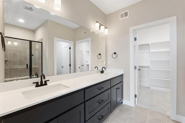 bathroom with vanity, tile patterned flooring, and an enclosed shower