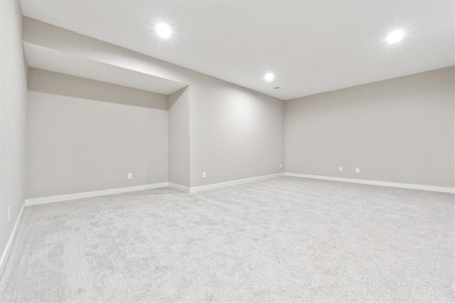 basement featuring light colored carpet