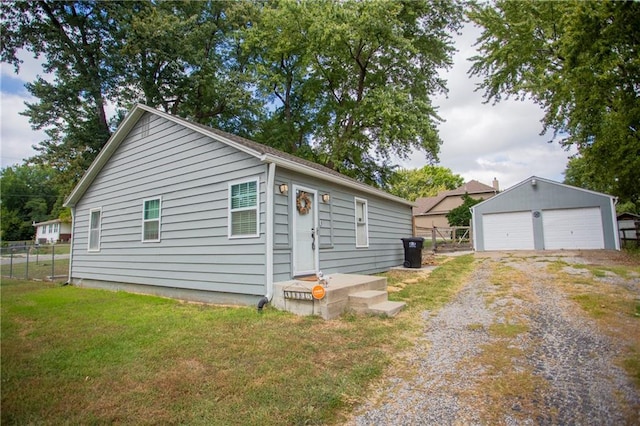 view of home's exterior with a yard, an outdoor structure, and a garage