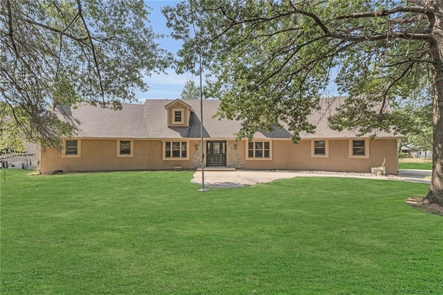 rear view of house with a lawn and a patio