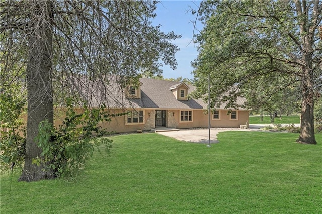 rear view of house with a lawn and a patio area