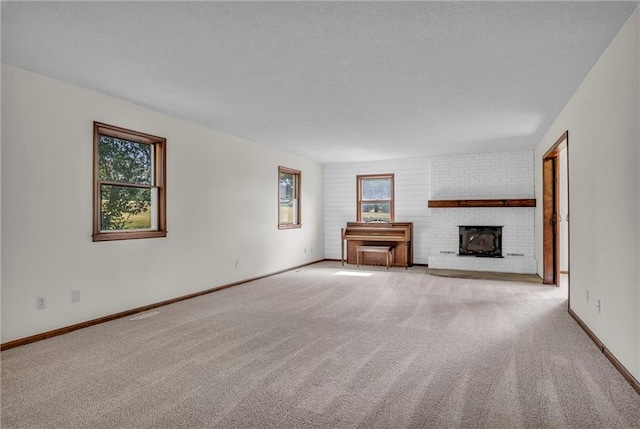 unfurnished living room featuring light carpet and a brick fireplace