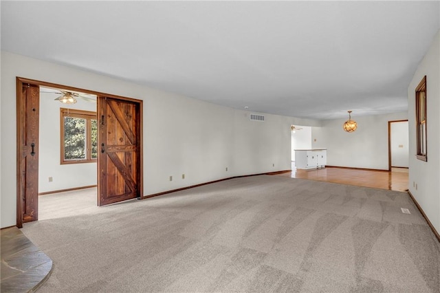 unfurnished living room with light colored carpet