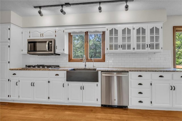 kitchen featuring white cabinetry, light hardwood / wood-style flooring, stainless steel appliances, and sink