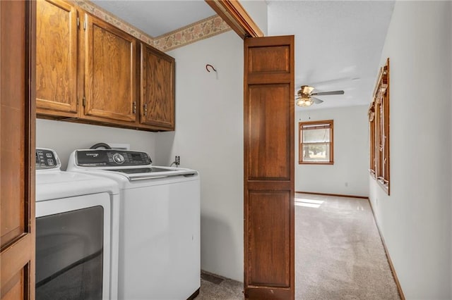 clothes washing area featuring washer and clothes dryer, ceiling fan, light colored carpet, and cabinets