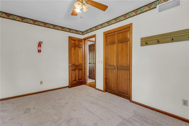 unfurnished bedroom with ceiling fan and light colored carpet