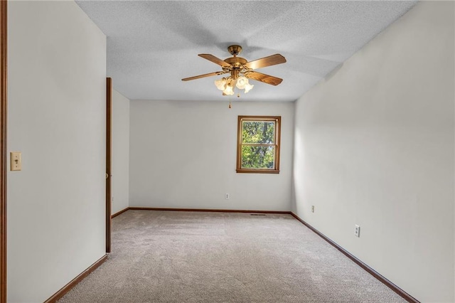 carpeted empty room featuring a textured ceiling and ceiling fan