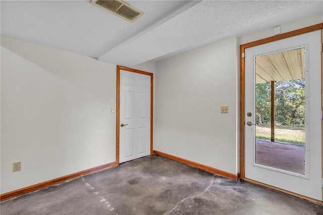 empty room featuring a textured ceiling