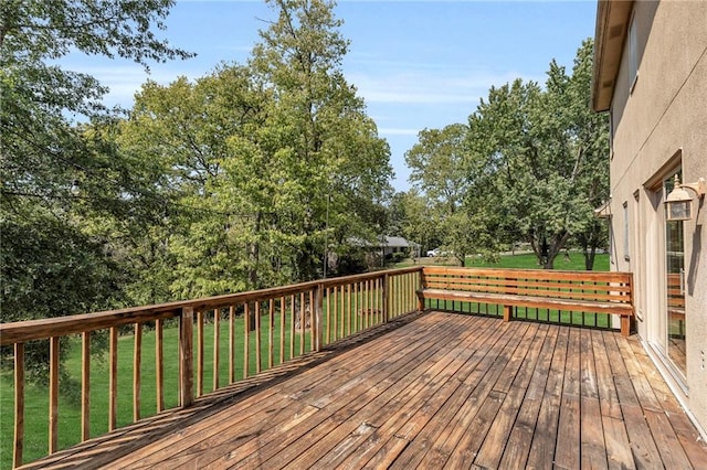 wooden deck with a lawn