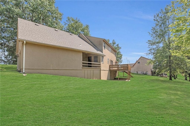 back of property with a wooden deck and a yard