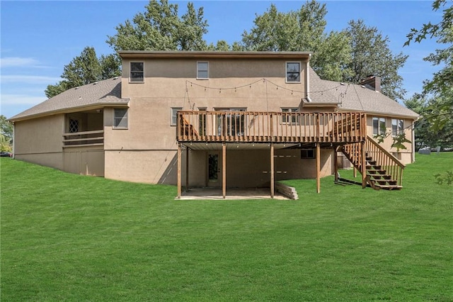 back of property with a yard and a wooden deck