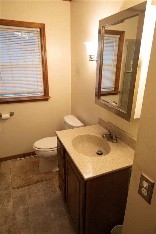 bathroom with toilet and vanity