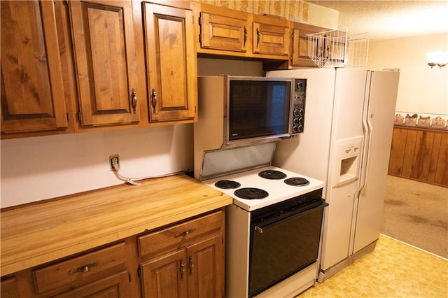 kitchen featuring white appliances and wooden counters