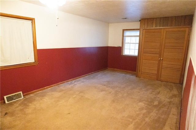 unfurnished bedroom with a closet and carpet floors