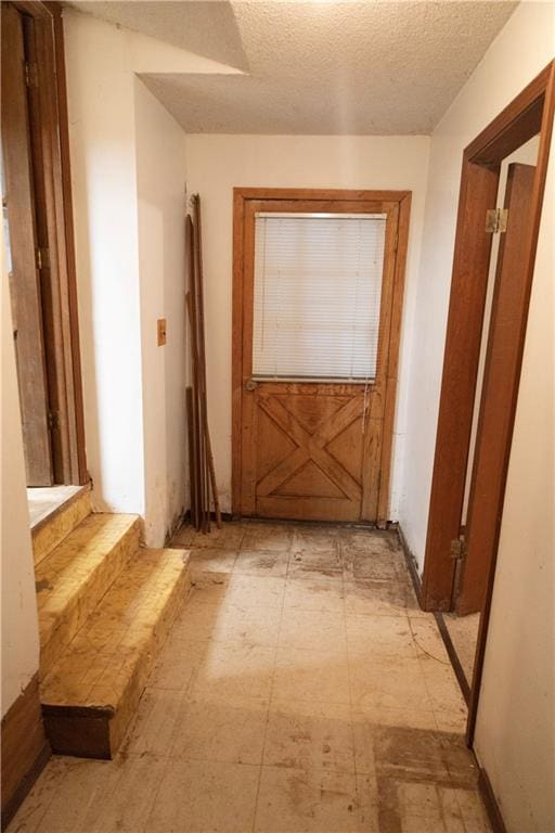 hallway with a textured ceiling