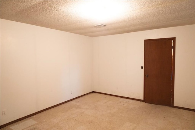 unfurnished room with a textured ceiling