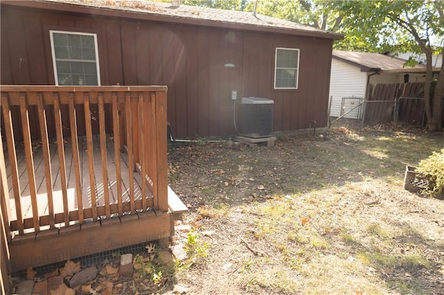 exterior space featuring central AC unit and a deck