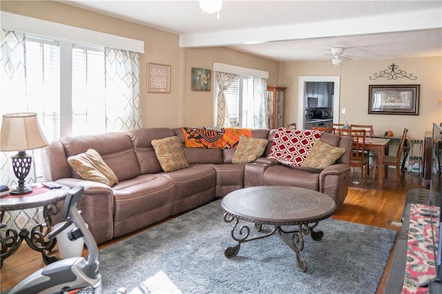 living room with plenty of natural light, hardwood / wood-style floors, beam ceiling, and ceiling fan